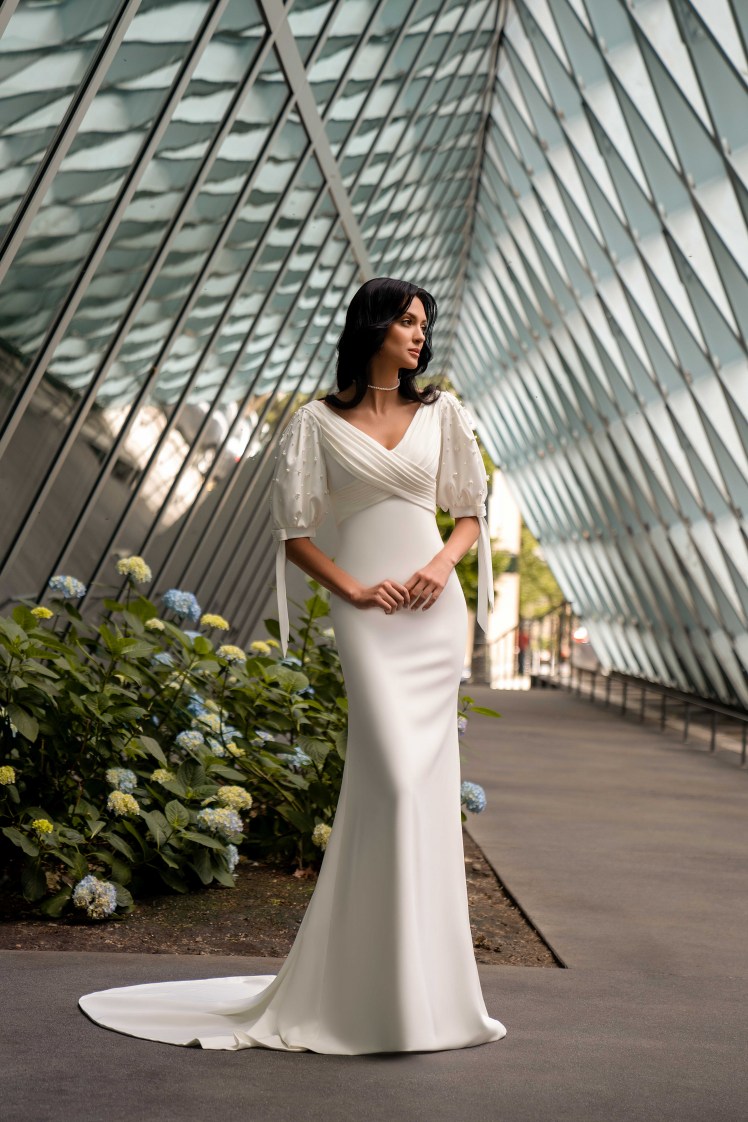 This incredible minimalist style wedding dress with a train skirt has a cropped bodice with a curved bottom-4