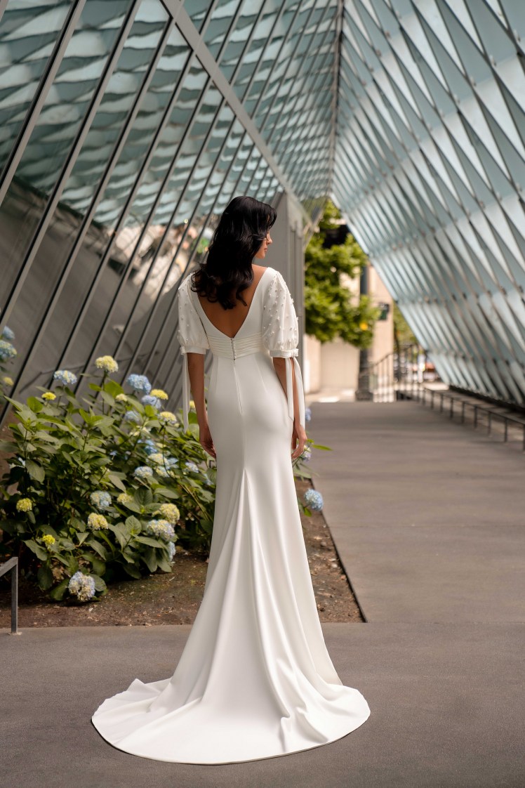 This incredible minimalist style wedding dress with a train skirt has a cropped bodice with a curved bottom-6