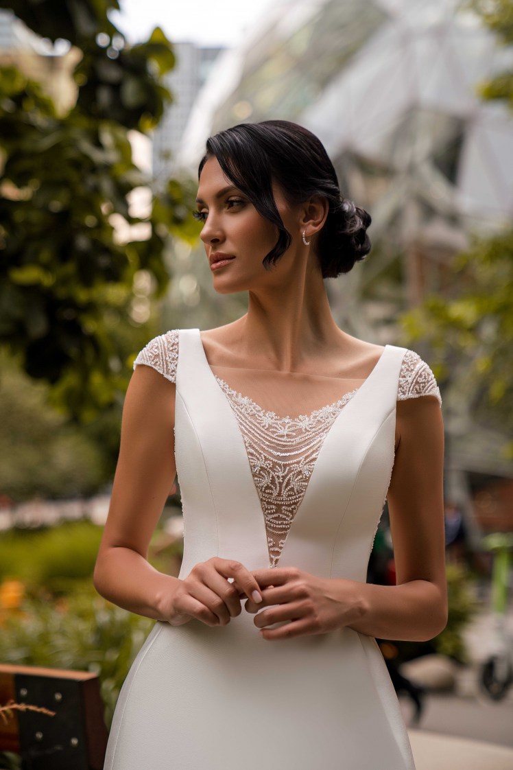 An unsurpassed minimalist wedding dress with winged straps and a train skirt is a true masterpiece of elegance.-6