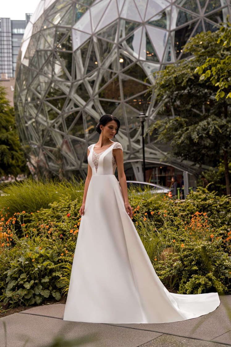 An unsurpassed minimalist wedding dress with winged straps and a train skirt is a true masterpiece of elegance.-4