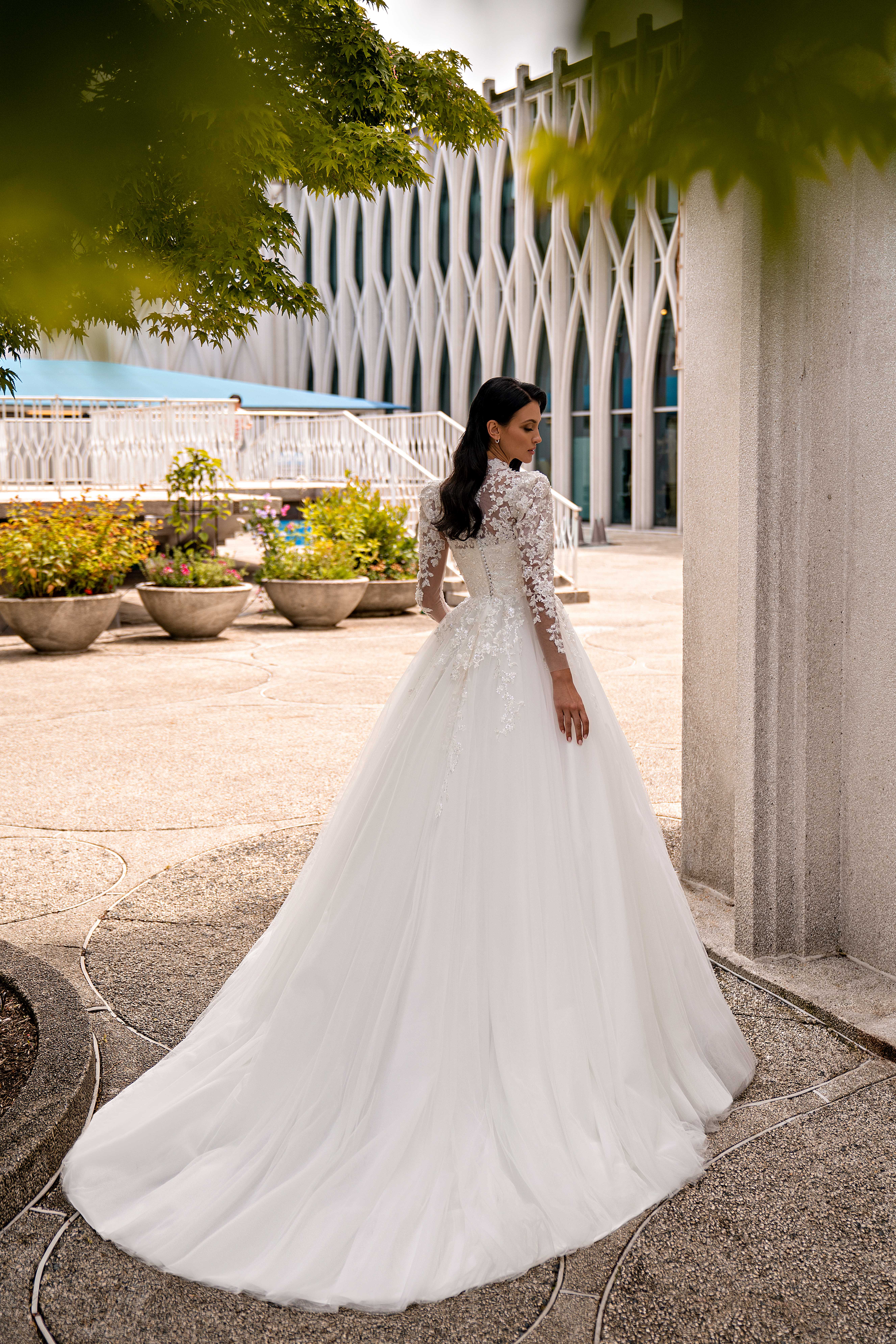 An incredible wedding dress with puffed sleeves and a train skirt fascinates with its luxury.-1